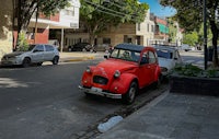 a red car parked on the side of a street