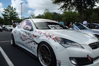 a white car with cherry blossoms painted on it