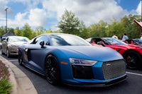 a blue audi r8 parked in a parking lot