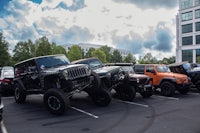 a group of jeeps parked in a parking lot